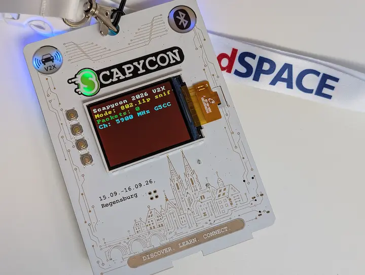 The ScapyCon 2026 electronic badge, show ing the V2X sniffer mode